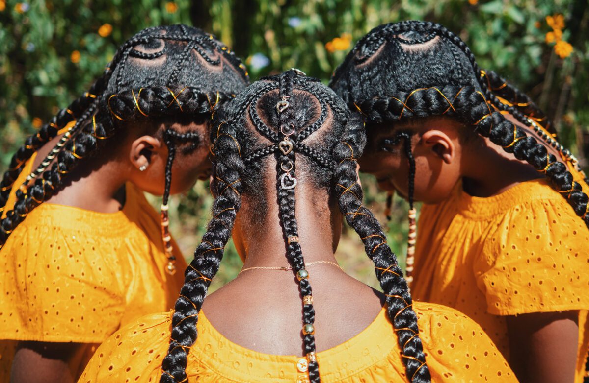 Three young women with elaborately braided hair
