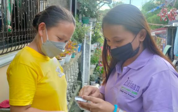 Two Pilipino young women sharing reproductive health information